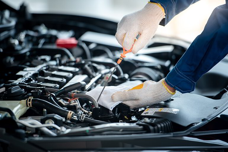 Technician carrying out mechanical repairs on a car engine