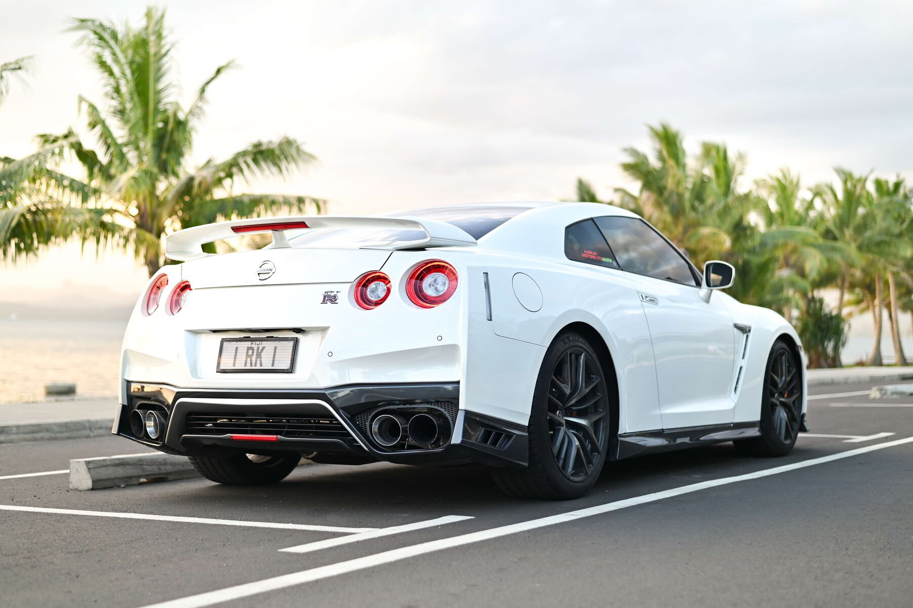 White Nissan GT-R with a 1 RK 1 Fiji number plate outside Aarkay Motors
